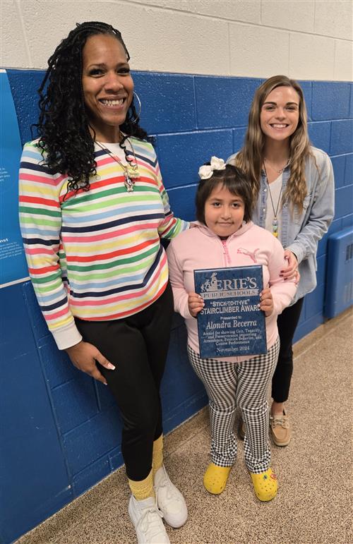 Alondra Becerra, Pfeiffer-Burleigh's November Stairclimber, poses with her plaque.